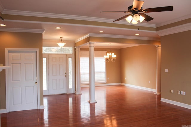 foyer with crown molding, ornate columns, wood finished floors, baseboards, and ceiling fan with notable chandelier