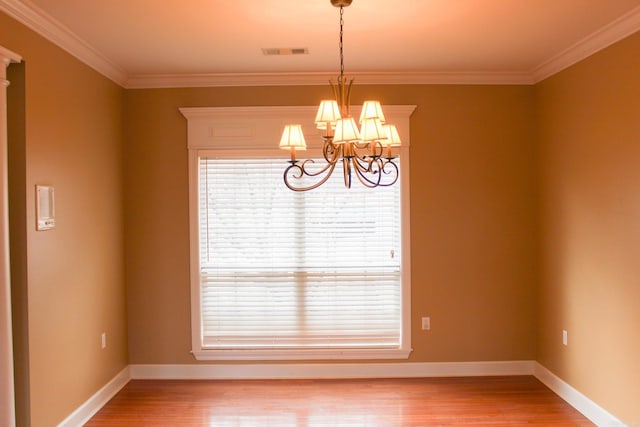 unfurnished dining area featuring baseboards, visible vents, a notable chandelier, and light wood finished floors