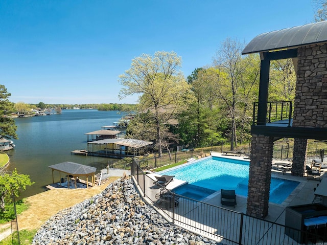 view of pool featuring a water view, fence, a fenced in pool, and a patio