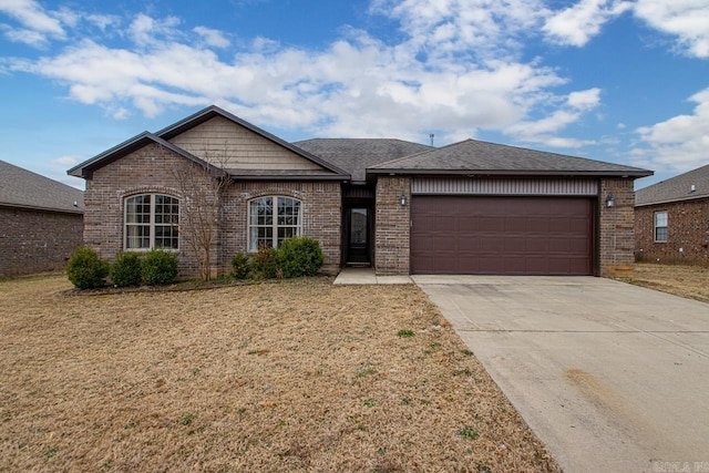 view of front facade featuring a front lawn, brick siding, driveway, and an attached garage