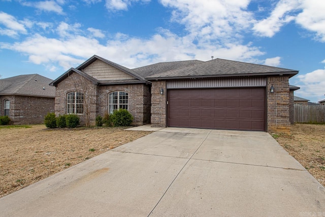 view of front of house with a garage, concrete driveway, brick siding, and a shingled roof