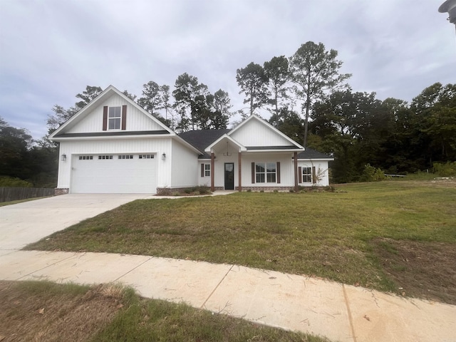 view of front of home featuring driveway, a garage, and a front lawn