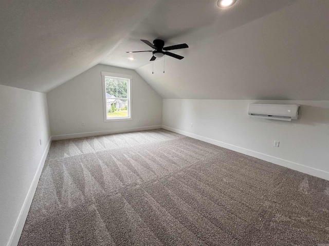 additional living space featuring lofted ceiling, carpet, baseboards, and a wall mounted AC