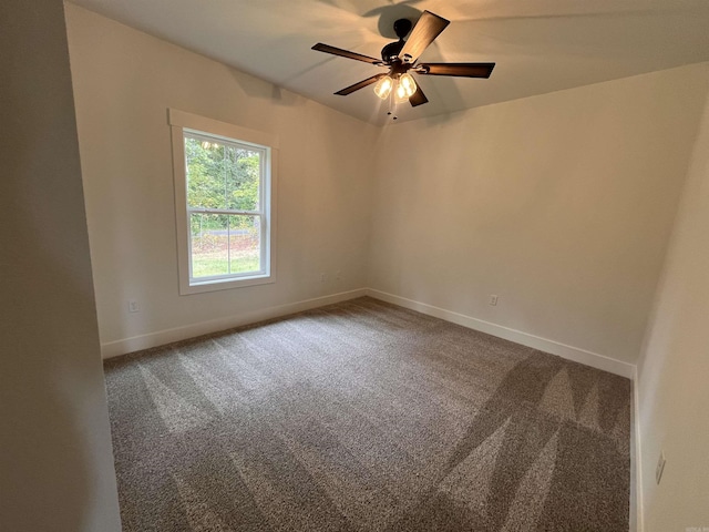 empty room with carpet, a ceiling fan, and baseboards