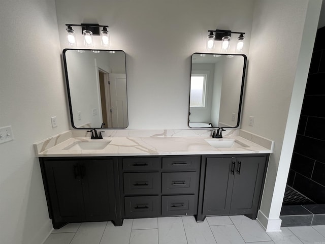 full bath with marble finish floor, a sink, and double vanity