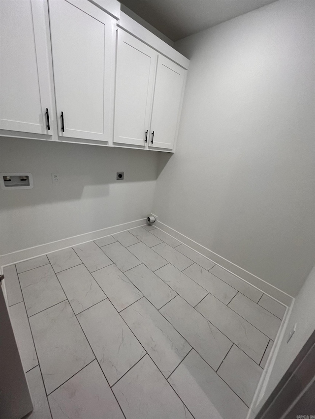 washroom with washer hookup, cabinet space, baseboards, and hookup for an electric dryer