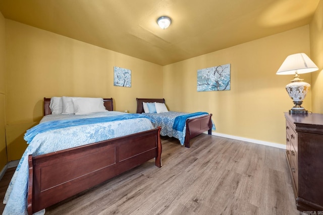 bedroom with baseboards and light wood-style floors