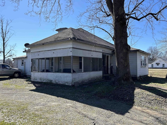 view of front of property featuring a sunroom and driveway