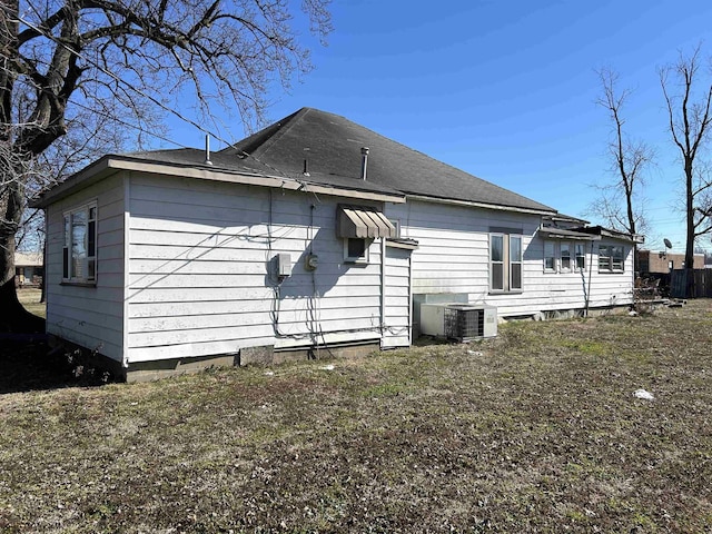 view of side of home with central AC