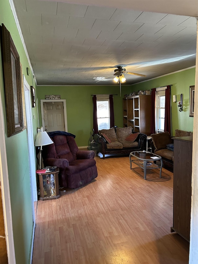 living room with plenty of natural light, wood finished floors, and a ceiling fan