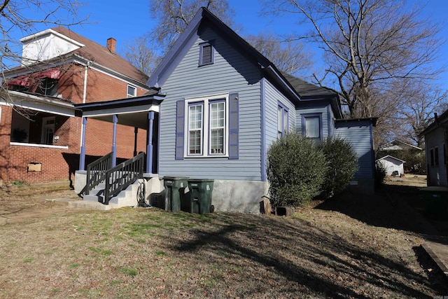 rear view of property with a yard