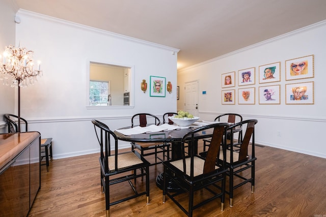 dining space featuring ornamental molding, wood finished floors, and baseboards