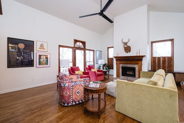 living room with high vaulted ceiling, wood finished floors, and a healthy amount of sunlight