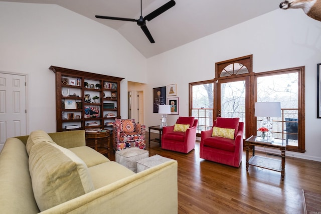 living area featuring high vaulted ceiling, a ceiling fan, and wood finished floors