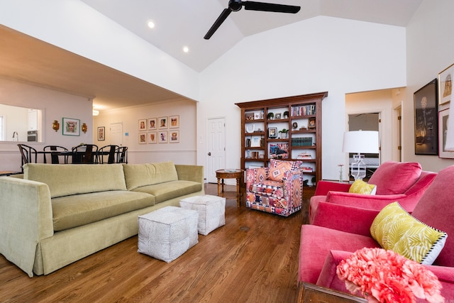 living area featuring high vaulted ceiling, a ceiling fan, and wood finished floors