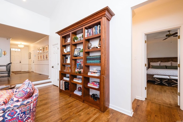 corridor with wood finished floors and baseboards