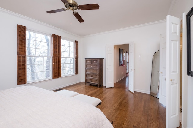 bedroom featuring baseboards, visible vents, arched walkways, wood finished floors, and crown molding