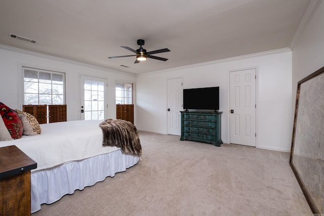 carpeted bedroom with a ceiling fan, baseboards, visible vents, and crown molding