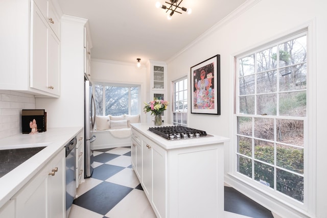 kitchen with crown molding, appliances with stainless steel finishes, white cabinetry, and tile patterned floors