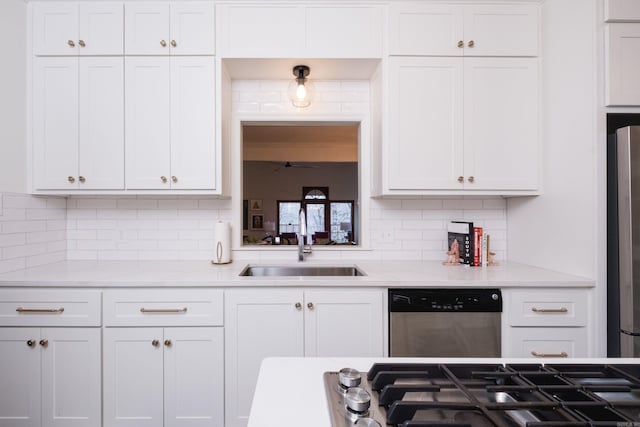 kitchen featuring a sink, white cabinetry, stainless steel appliances, and backsplash