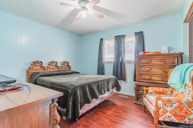 bedroom featuring ceiling fan, visible vents, dark wood finished floors, and baseboards