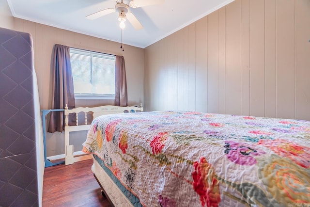 bedroom with dark wood-style flooring, a ceiling fan, and crown molding