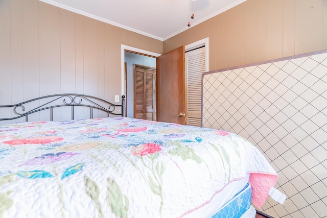 bedroom featuring ornamental molding and a closet