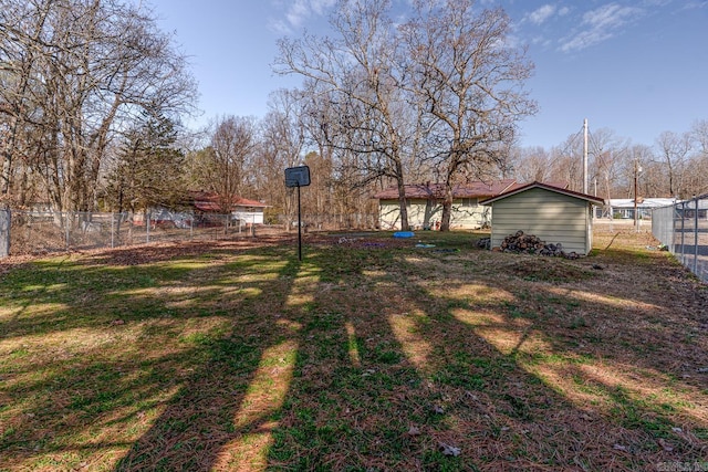 view of yard featuring an outdoor structure and fence