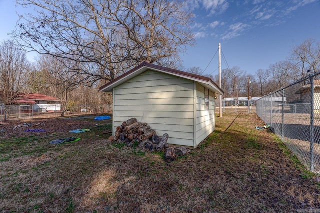 view of outbuilding featuring fence and an outdoor structure