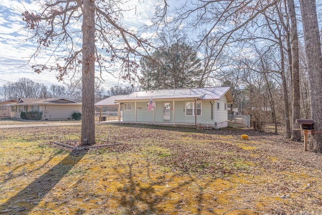 view of front of home featuring a porch and metal roof