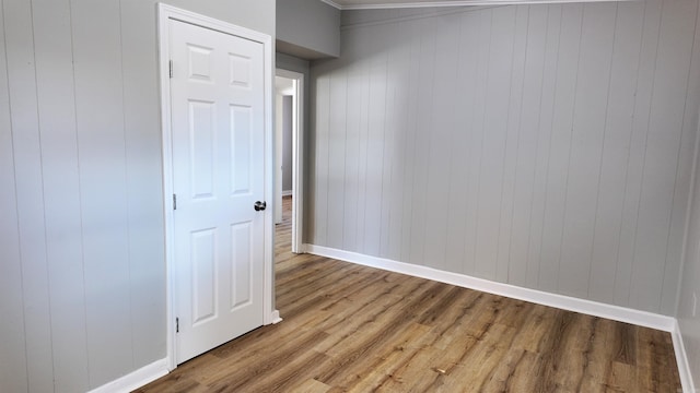 empty room featuring baseboards and wood finished floors