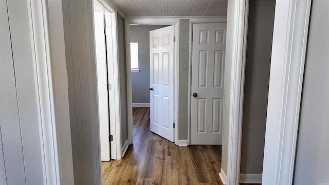 hallway featuring baseboards and light wood-style floors