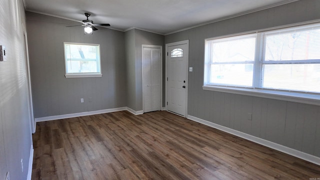 entrance foyer with ornamental molding, plenty of natural light, and wood finished floors