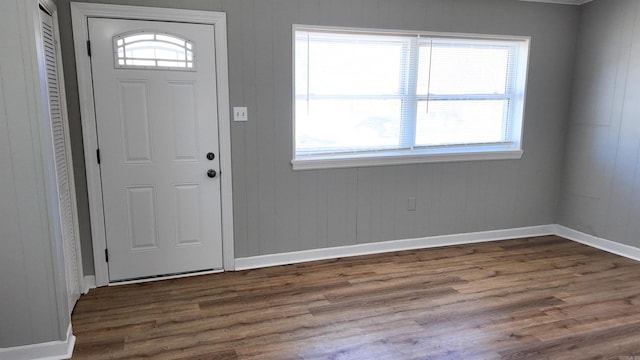 entryway with dark wood finished floors and baseboards