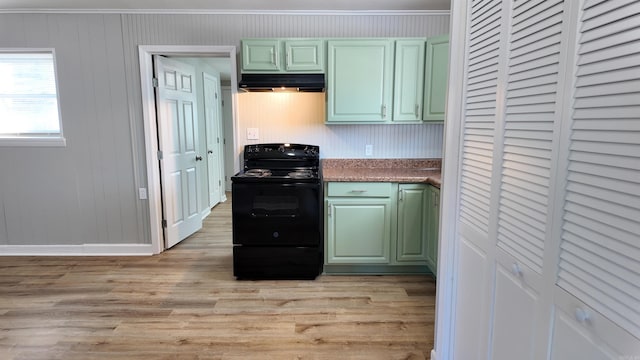 kitchen with under cabinet range hood, black range with electric cooktop, green cabinets, and light wood-style floors