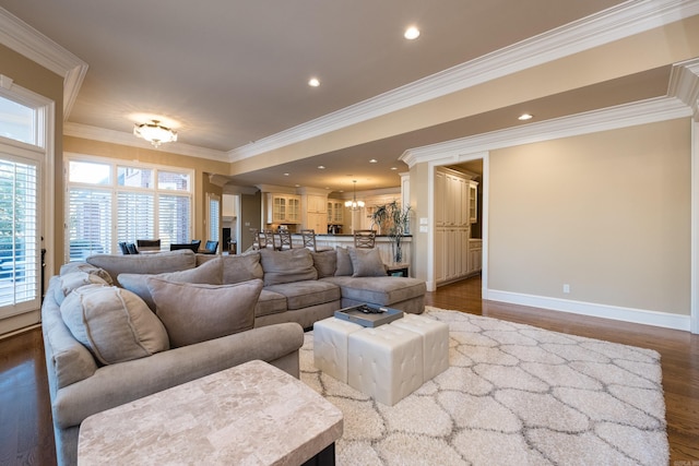 living room featuring baseboards, dark wood-style flooring, an inviting chandelier, crown molding, and recessed lighting