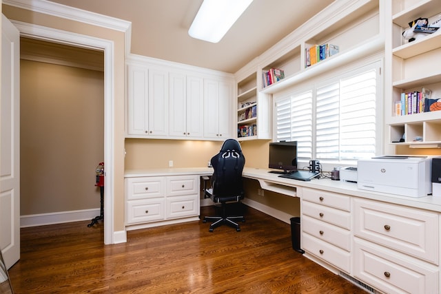 office with baseboards, dark wood-type flooring, and built in desk