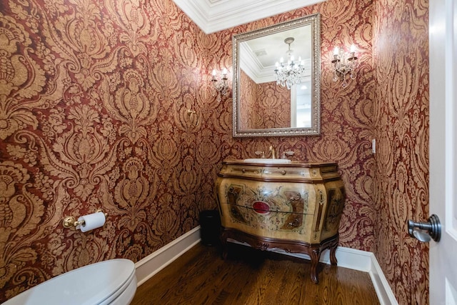 bathroom featuring baseboards, ornamental molding, and wood finished floors