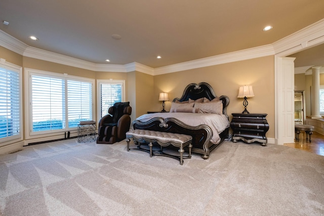 carpeted bedroom featuring ornamental molding, recessed lighting, visible vents, and ornate columns