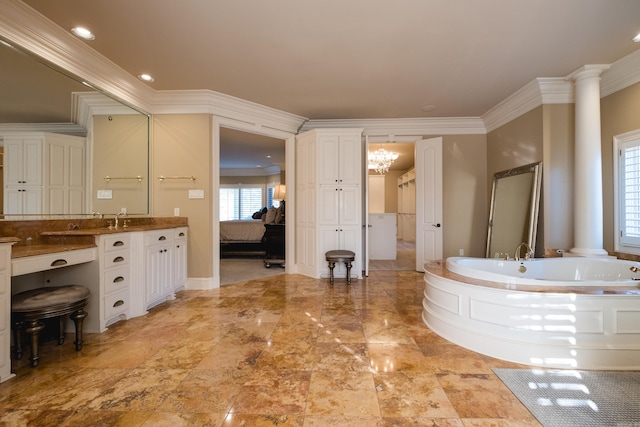 bathroom featuring crown molding, decorative columns, ensuite bathroom, and a bath