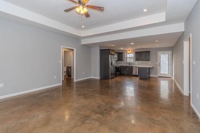 1108 Ava Ln, Paragould, AR 72450 - unfurnished living room with baseboards, a ceiling fan, concrete flooring, a sink, and recessed lighting
