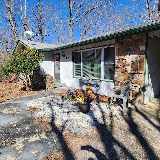 view of front of home featuring stone siding and a porch