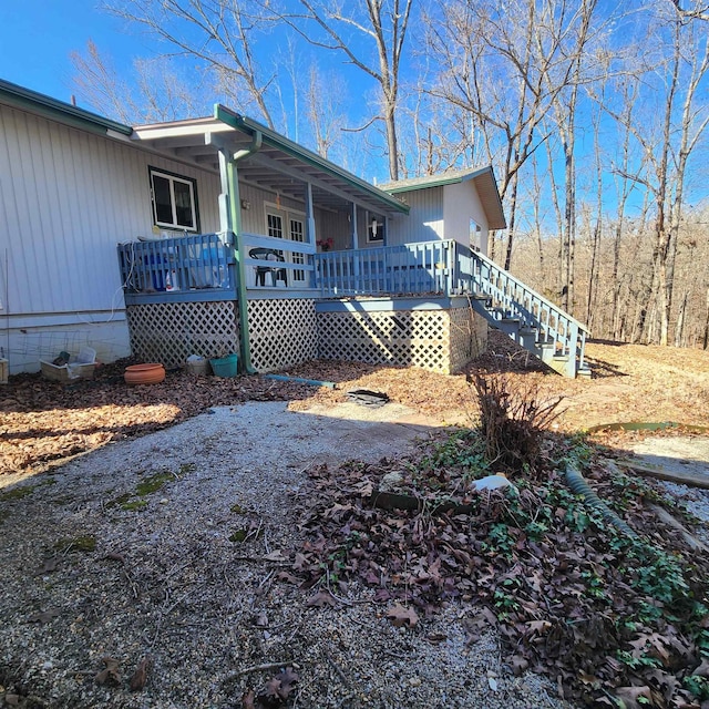 view of property exterior with covered porch and stairway