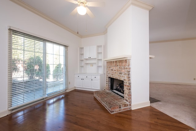 unfurnished living room with a brick fireplace, baseboards, ornamental molding, and dark wood-type flooring