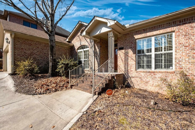 doorway to property with brick siding