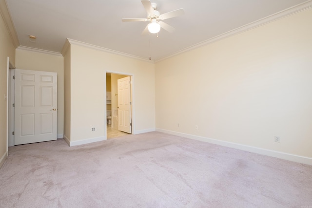 unfurnished bedroom featuring baseboards, a ceiling fan, light colored carpet, ensuite bath, and ornamental molding