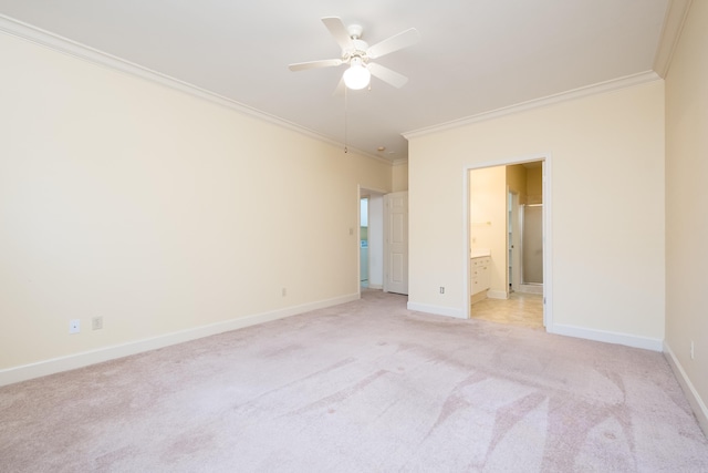 unfurnished bedroom featuring light colored carpet, crown molding, ensuite bath, and baseboards