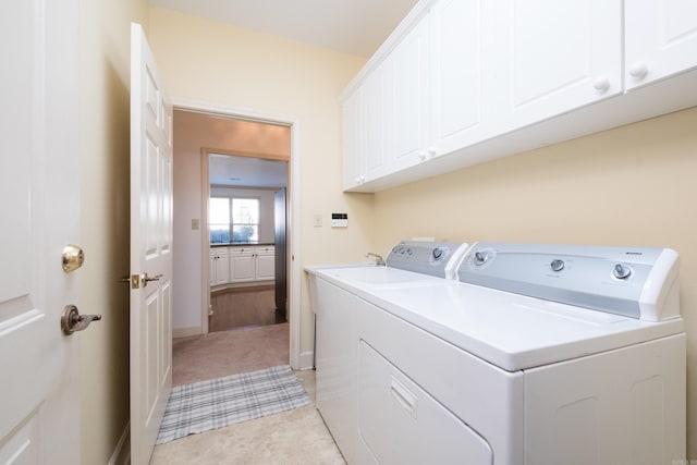 washroom with cabinet space and separate washer and dryer