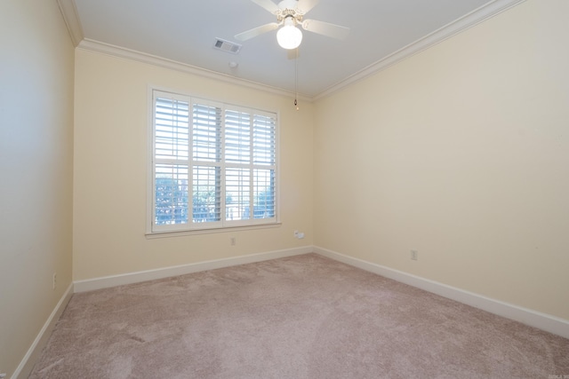 unfurnished room featuring carpet floors, visible vents, baseboards, a ceiling fan, and ornamental molding