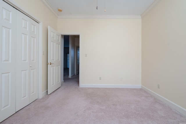 spare room with light carpet, baseboards, and ornamental molding